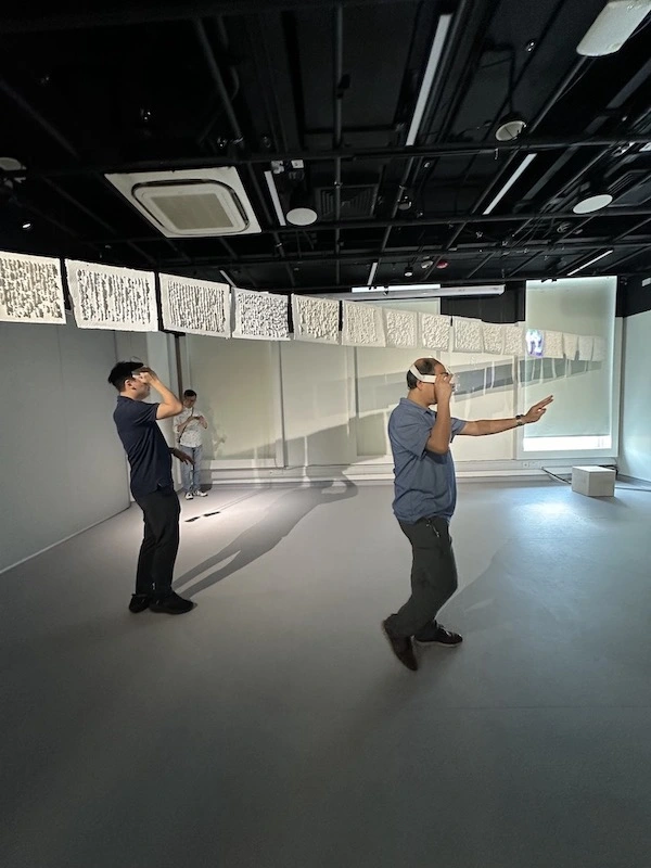 A captivating blend of the tangible and the virtual. Visitors interact with an art installation that blurs the lines between physical and digital spaces.